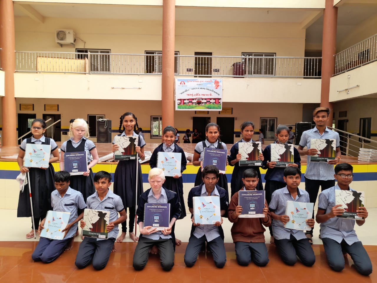 Students of Pragna School, Shivarimal holding tactile books in their hands.